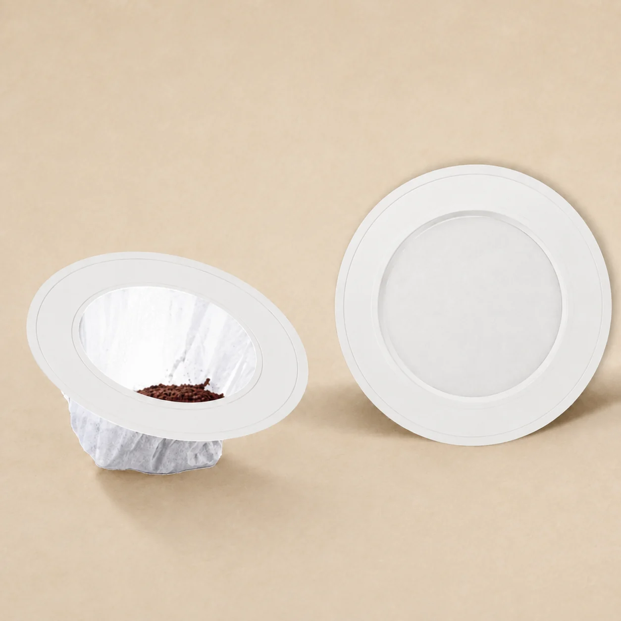 White UFO coffee package filled with ground coffee on a warm beige background